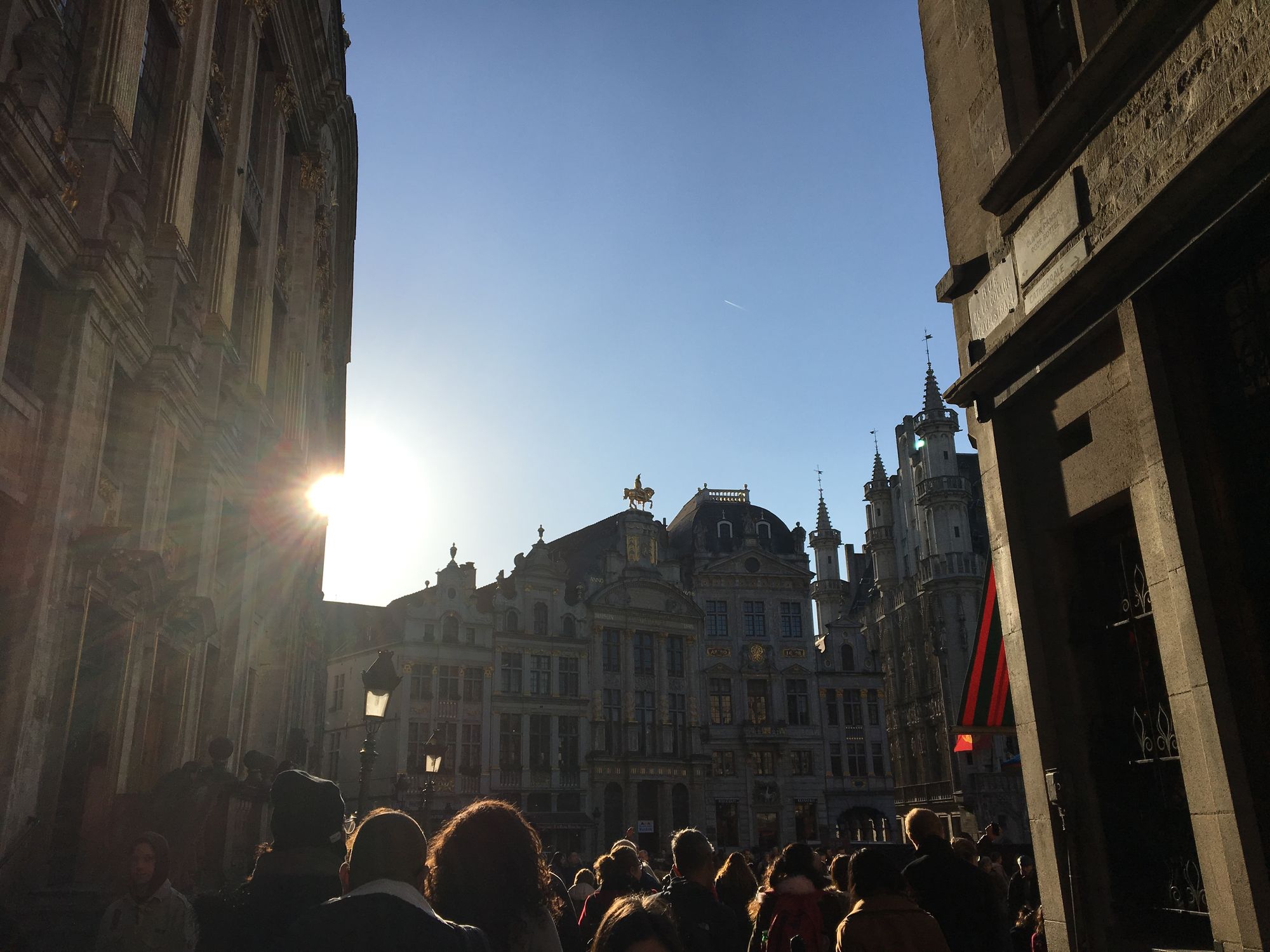 A photo of a crowd flowing into The Grand Place square